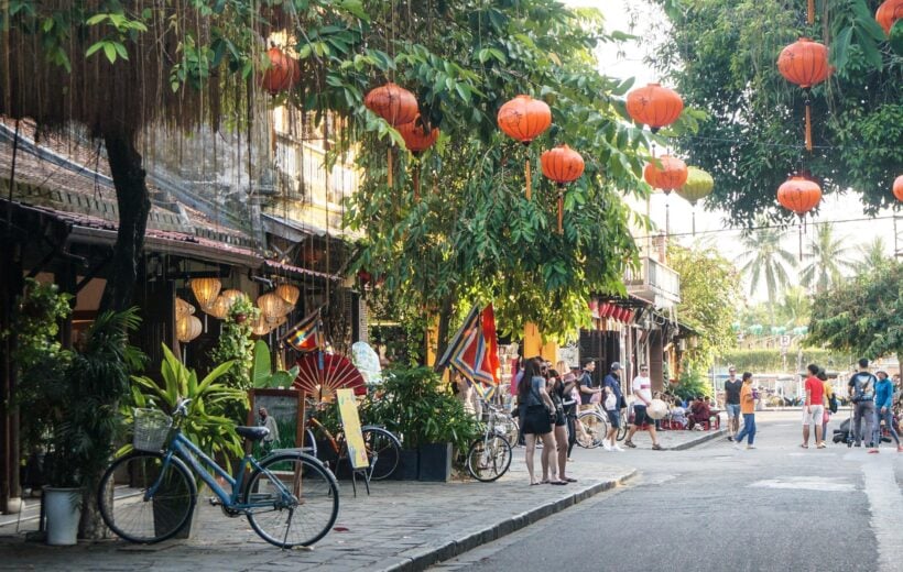A bustling Hoi An street with lanterns hanging overhead